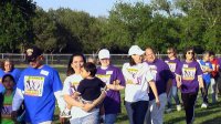 Survivors wear purple shirts and lead the walkers.